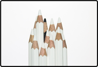 twelve colored pencils in a bunch, all white except one black on a white background