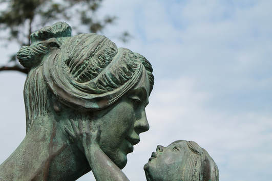 Sculpture of a daughter holding a mother's face