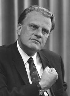 Black and White picture of younger Billy Graham with his fist up